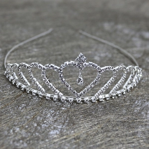 Detailed macro view of silver crown tiara with heart pattern and water drop rhinestone