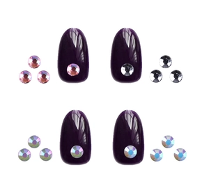 Detail of dark purple glossy fake nails decorated with tiny rhinestones and crystals