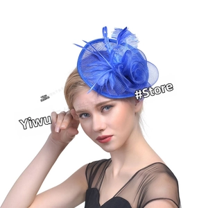 Close-up of deep blue mesh net and feather fascinator hair accessory for weddings