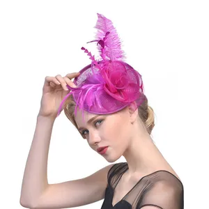 Detailed view of rose red fascinator with elegant mesh veil, silk flower and soft feathers