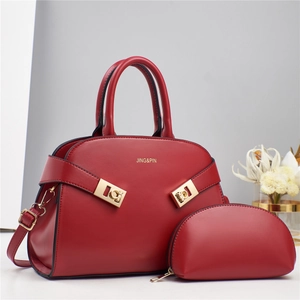Elegant red leather handbag set with two pieces, featuring a top-handle bag and gold hardware