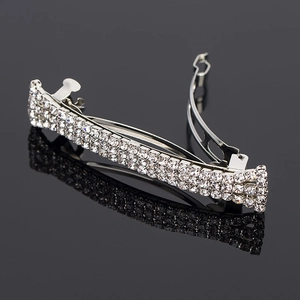 Detailed side view of silver alloy hair clip with three rows of sparkling rhinestones