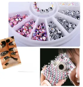 Macro detail of mixed color acrylic nail rhinestones in a circular organizer wheel case