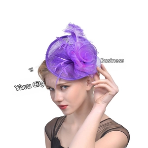 Detail of elegant purple mesh fascinator with delicate feathers for wedding banquets