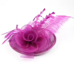 Close-up of fuchsia fascinator showing intricate mesh flower and elegant feather details