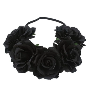 Bohemian black rose floral headband with silk petals and green leaf accents on a black band