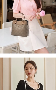 Detail of a brown woven leather handbag with dual handles and gold metal accents