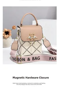 Detail of pink and beige crossbody bag with swan buckle and pearl rhinestone tassel