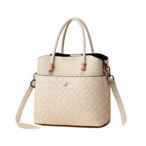 Detail of cream white women shoulder bag with quilted textures and adjustable strap
