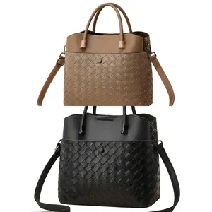 Detail of woven leather textures on khaki and black shoulder bags with dual handles