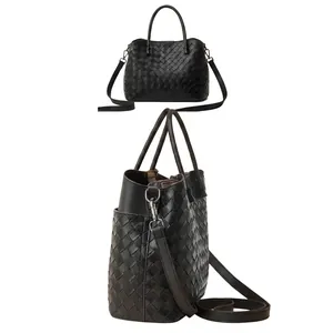 Detail of hand-woven black leather handbag featuring silver hardware and side pocket view