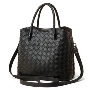 Detailed back view of a black woven leather tote bag showing fine texture and base structure