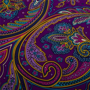 Detail of bohemian paisley floral pattern on dark purple silk scarf fabric