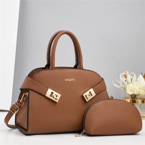 Detailed view of brown litchi pattern leather handbag set with adjustable strap