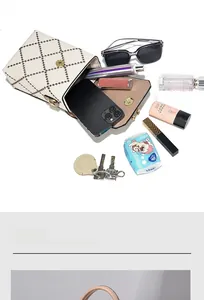 Detail view of cream quilted crossbody bag interior with magnetic gold snap closure