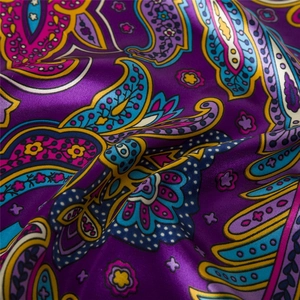 Macro shot of purple Paisley pattern silk scarf with elegant satin luster and texture