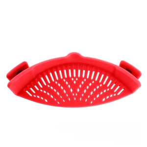 Detail of red heat-resistant silicone pot strainer with dual spring clips for draining