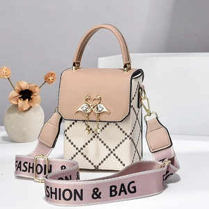 Elegant beige and pink quilted crossbody bag with heart buckle and wide fabric strap