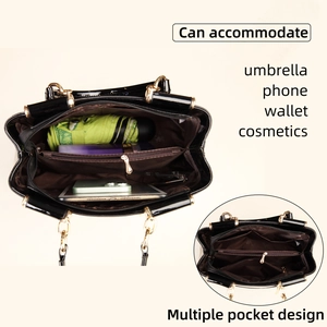 Interior view of black glossy tote showing multi-pocket storage and large capacity