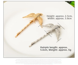 Macro shot of gold and silver swallow hair clips featuring detailed wing textures