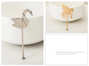 Detail of origami style swan and pegasus hair clips in silver and gold alloy finish