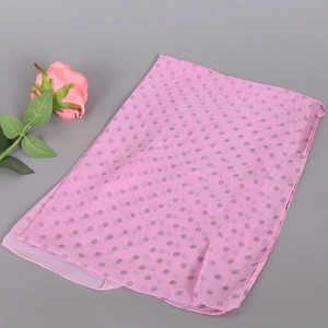 Detailed macro view of pink chiffon scarf with grey polka dots and fine stitched edges