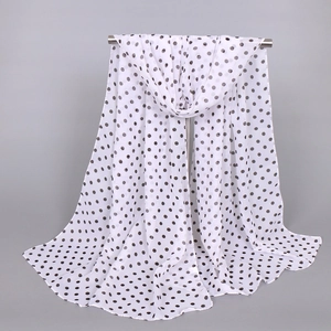 Classic white chiffon long scarf with black polka dots shown hanging on a metal stand