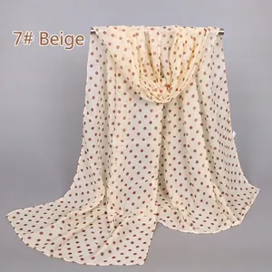 Detail of sheer cream chiffon scarf with brown polka dots showing fabric drape and texture