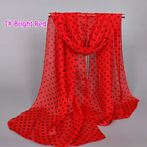 Detail of red chiffon scarf with black polka dots showing light fabric texture