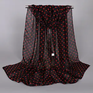 Detailed texture of lightweight black chiffon scarf with red polka dots pattern