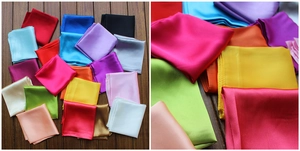 Detailed view of multi-color satin square scarves showcasing smooth texture and silk-like shine