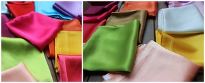 Detailed view of colorful satin silk scarves showing glossy texture and stitched edges