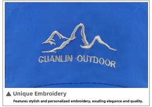 Détail de la broderie de montagne et texte GUANLIN-OUTDOOR sur casquette bleu marine