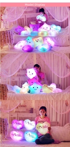 Luminous star and heart plush pillows with colorful LED lights shown in a cozy bedroom