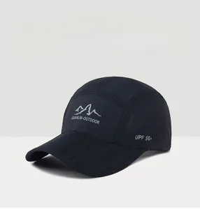 Detail of black quick-dry outdoor hat showing UPF 50+ logo and breathable fabric texture