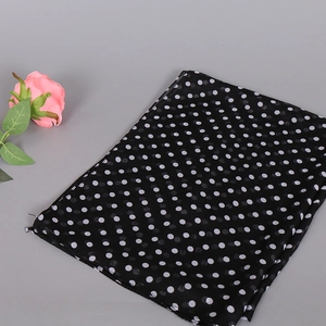 Close-up of lightweight polka dot chiffon scarf with semi-transparent texture fabric