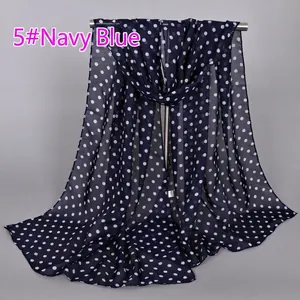 Detail of navy blue chiffon scarf with white polka dots showing lightweight fabric texture