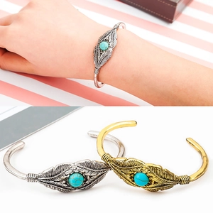 Vintage feather cuff bracelet with turquoise inlay in silver and gold tone finishes