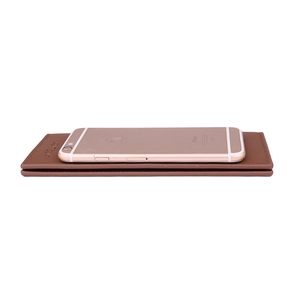 Slim brown leather long wallet for men with smartphone for size comparison on white background