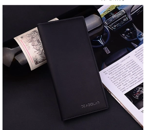 Macro shot of minimalist long black leather wallet with DEABOLAR embossed logo on black background