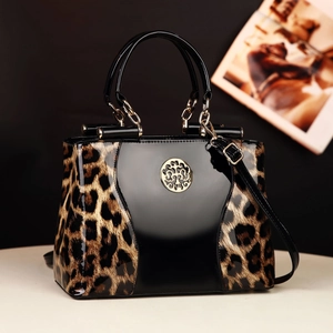 Leopard print and black patent leather handbag with gold logo and crossbody strap