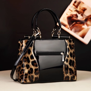 Fashionable leopard print and black patent leather crossbody handbag with chain straps