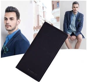 Close-up of slim black long wallet for men held by a model in a dark blue formal suit