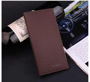 Brown leather long wallet for men placed next to a wine bottle in a business setting