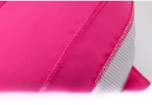 Detailed macro view of rose red quick-dry mesh fabric and reinforced double-stitch seams