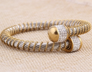 Detailed close-up of two-tone twisted cable bracelet with crystal-pave accents