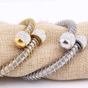 Two-tone woven spring steel wire bangle set with sparkling diamond-encrusted sphere ends