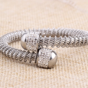 Macro shot of silver stainless steel cable twisted bracelet with diamond-set end caps