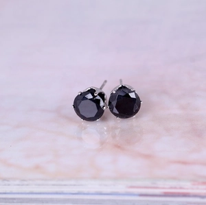 Detailed close-up of 8mm round black zircon stud earrings with six-prong silver setting