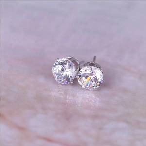 Classic 8mm round zircon stud earrings with silver 6-prong setting on marble base